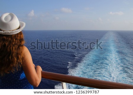 Lady on a cruise ship, watching the caribbean sea