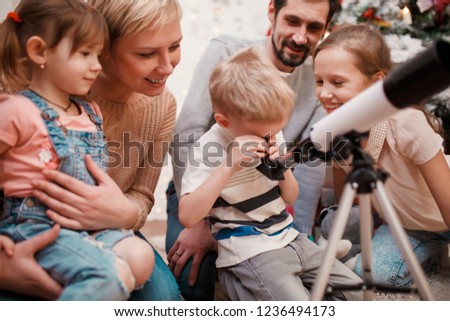 Photo of happy family with telescope
