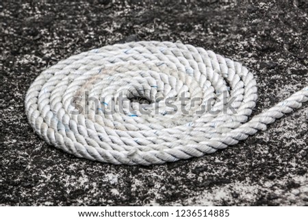 coiled rope on stone floor