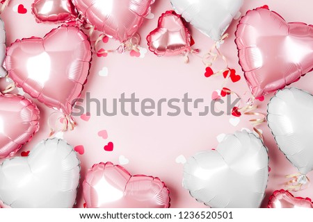 Air Balloons of heart shaped foil  on pastel pink background. Love concept. Holiday celebration. Valentine's Day or wedding/bachelorette party decoration. Metallic balloon Royalty-Free Stock Photo #1236520501