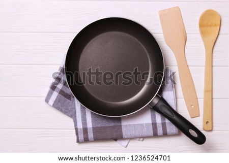frying pan and on the wooden table top view. Cooking.
