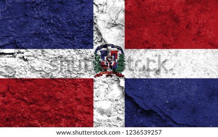 Flag of Dominican Republic close up painted on a cracked wall, concept of armed actions and conflicts in the world
