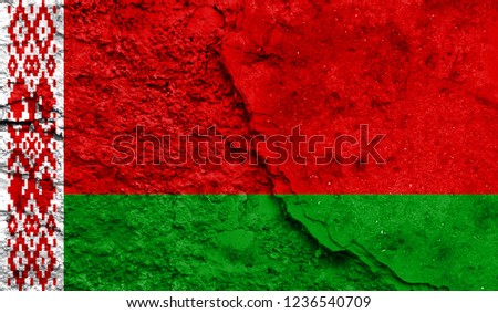 Flag of Belarus close up painted on a cracked wall, concept of armed actions and conflicts in the world