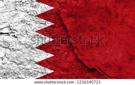 Flag of Bahrain close up painted on a cracked wall, concept of armed actions and conflicts in the world