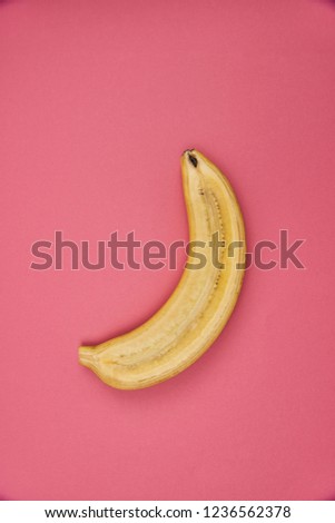 banana in section lies on a pink background