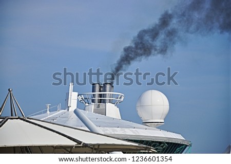 Smoke coming from the chimney of a ship Royalty-Free Stock Photo #1236601354