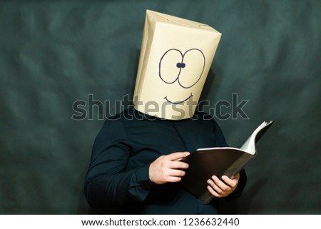 Emotion concept. A man is reading a book. Facial expression joy and smile.