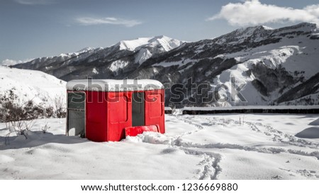 A red shelter in beautiful snowy mountains while passing by Gudauri caucasus mountain in Mtskheta, Georgia 