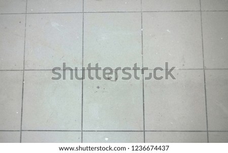 Texture of old dirty tiled floor during renovation work in a residential or public place.