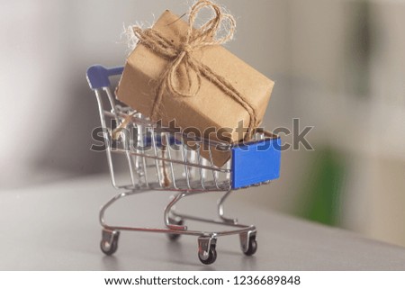 A huge gift with a craft ribbon in a shopping cart