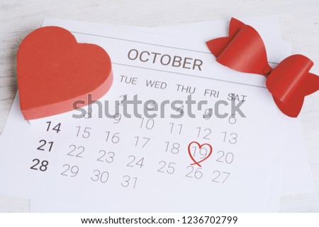 October calendar with red gift box. Date Night, love concept.