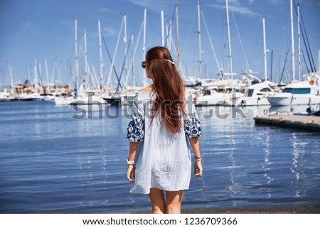 Young woman on the background of the blue sky.