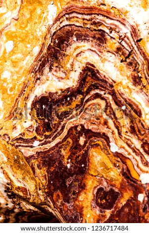 The texture of a marble rock with lines and colors