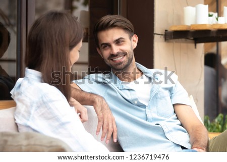 Happy smiling handsome man having good conversation with young woman, boyfriend looking at girlfriend, having fun together, first date concept, friends share thoughts, pleasant news in cafe Royalty-Free Stock Photo #1236719476