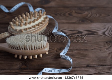 Close up two wooden soft massage brushes for body and legs. With copy space for text. Concept of cosmetology, weight loss, spa, beauty, cellulite.