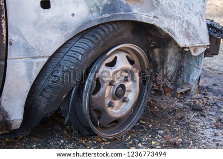 Closeup photo of a damaged car wheel caused by fire.