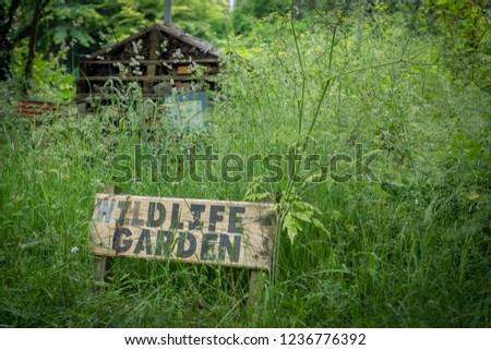 Wildlife garden sign leading through to natural growth