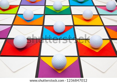 Composition with colored envelopes and golf balls on the table. The photo suitable for various holidays and anniversaries.