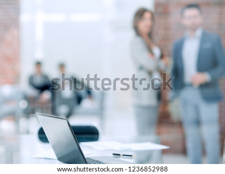 background image of a desktop in a modern office
