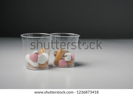 daily tablet dosage in small plastic containers