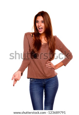 Portrait of an excited young woman speaking and screaming on brown t-shirt against white background