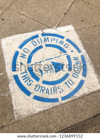 No Dumping drains to the ocean sign