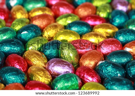 Colorful chocolate Easter eggs forming a background