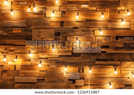 Modern dark classical style interior design apartment with retro lamps hanging light bulbs background. Wooden planks with lamps. Decorated interior room with gold lights. Copy space mockup poster