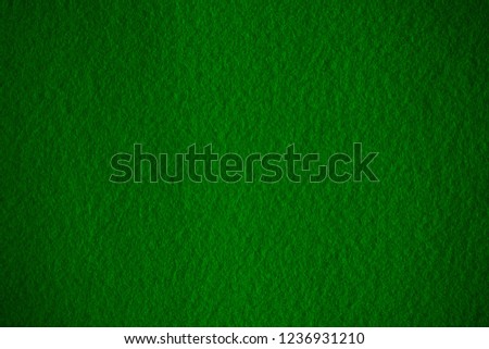 
Poker table felt background in dark green color with shade vignette.
