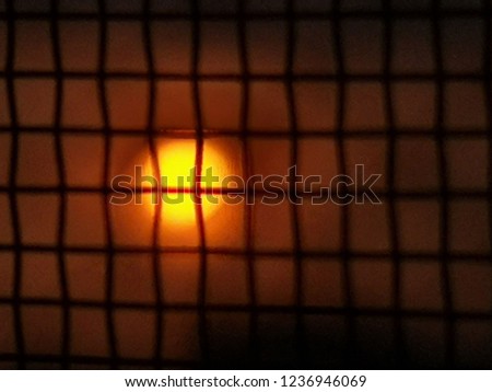 blurred photo,​ Sunrise Look through the steel mesh.