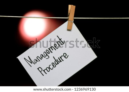 little blur text on Management Procedure handwriting on paper. Hanged with a clothes clips, medical and education concept. light blur background