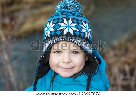 Portrait of little boy of two years in blue clothes outdoor