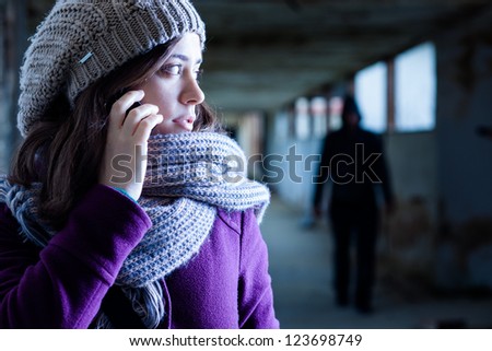 Worried Woman Stalked by a Man Royalty-Free Stock Photo #123698749