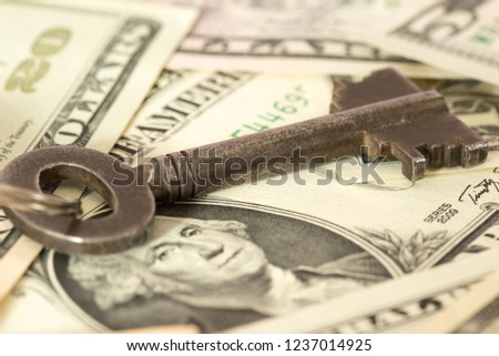 A key and dollar bills