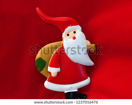 Christmas season theme with Santa Claus in red background.