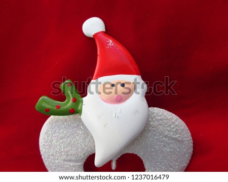 Christmas season theme with Santa Claus in red background.