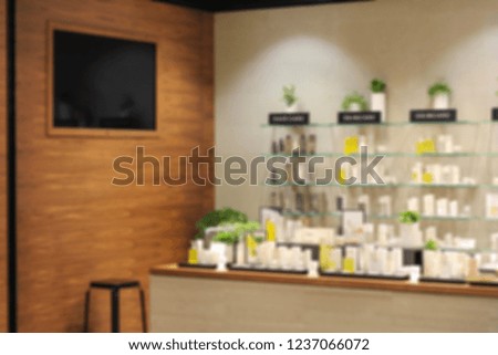 Cosmetics placed on shelves and TV on the wall. blur