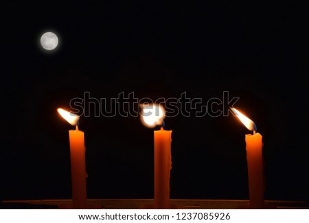 Abstract soft blurred and soft focus candle flame on the dark background, candles in Buddhist festival days, Buddhist worship or prayer.