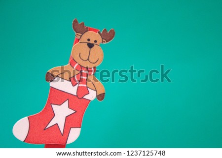 Toy elk in a New Year's stocking on a blue background. Animation for a happy new year greeting card. Christmas card. Background for text.
