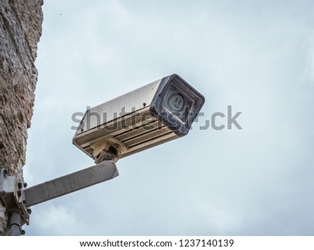 dirty surveillance camera with dust cover on the front element