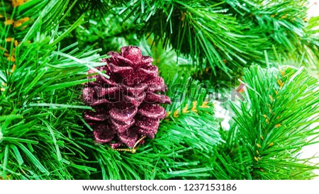 Beautiful Christmas ornaments. Christmas decoration in the form of the pine cone, in the background, branches Christmas tree.