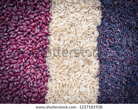 Thai black jasmine rice berry agricultural produce with purple rice , brown rice and red kidney bean organic food background  
