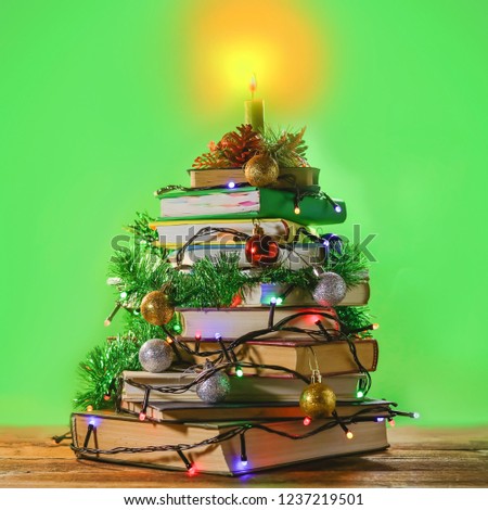 a stack of books decorated with New Year and Christmas decorations Royalty-Free Stock Photo #1237219501
