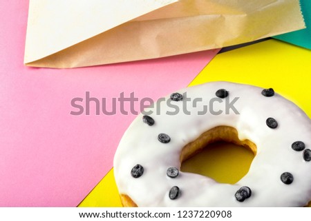 donut with white icing on a colorful background