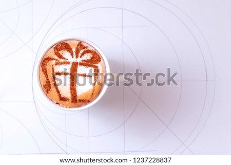 COFFEE Cappuccino with a picture of a gift on milk foam