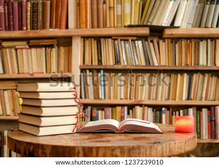 Vintage books on table in a library Royalty-Free Stock Photo #1237239010