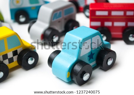 closeup of  miniature wooden cars on white background - concept traffic 