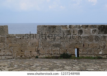 Antique fortress wall against the sea. 
 Ruins of an ancient castle(fragment). Kyrenia castle.The Turkish Republic Of Northern Cyprus