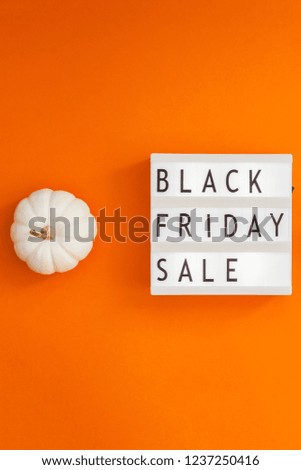 Creative Top view flat lay promotion composition Black friday sale text on lightbox alarm clock orange background copy space Template Black friday sale mockup fall thanksgiving promotion advertising