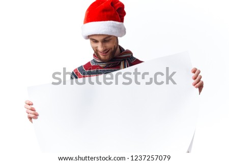 man in holiday hat looks at a white sheet of paper in his hand Poster mockup                              
